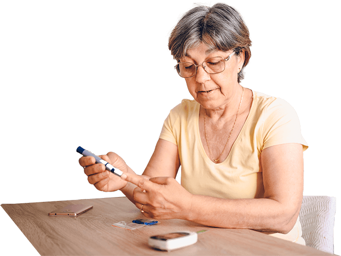 An elderly woman is testing her blood sugar level with a tester.